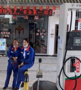 Two women in uniform at gas station