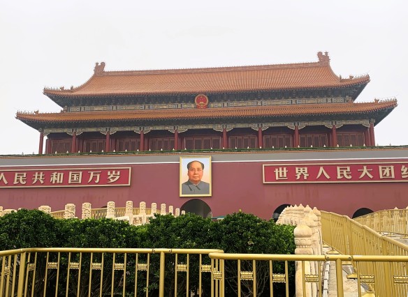 Large Chinese style gate with Mao Zedong's portrait hanging above the entrance