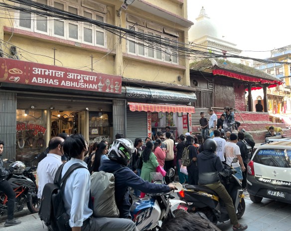 Busy street scene of scooters and people