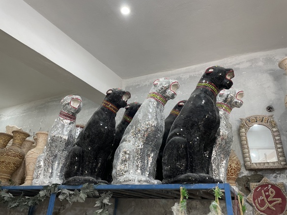 Cat shaped statues covered in mirrored tiles