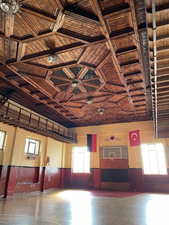 Indoor basketball court with elaborate wooden ceiling
